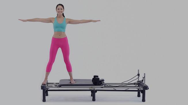 You Can Get a Reformer-Level Pilates Workout With Just Two Simple Pieces of  Equipment